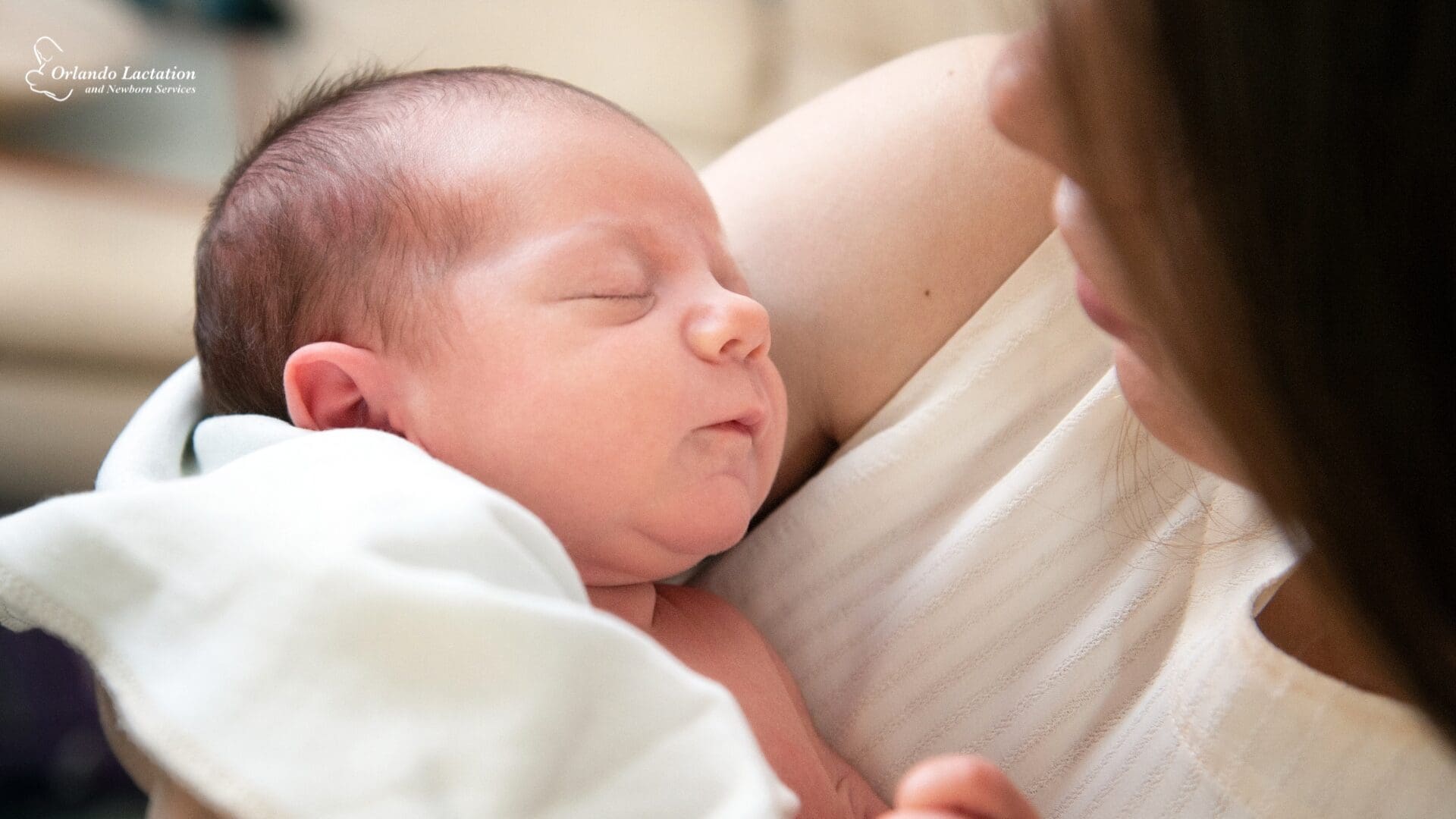 baby being held by woman